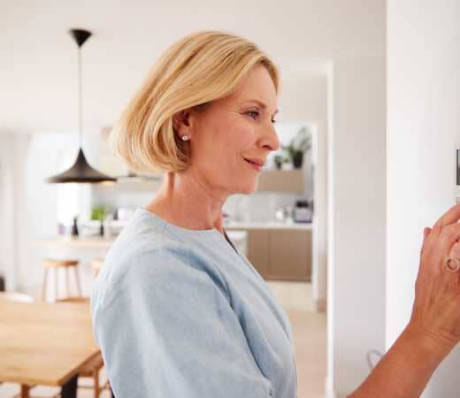 Woman checking thermosat